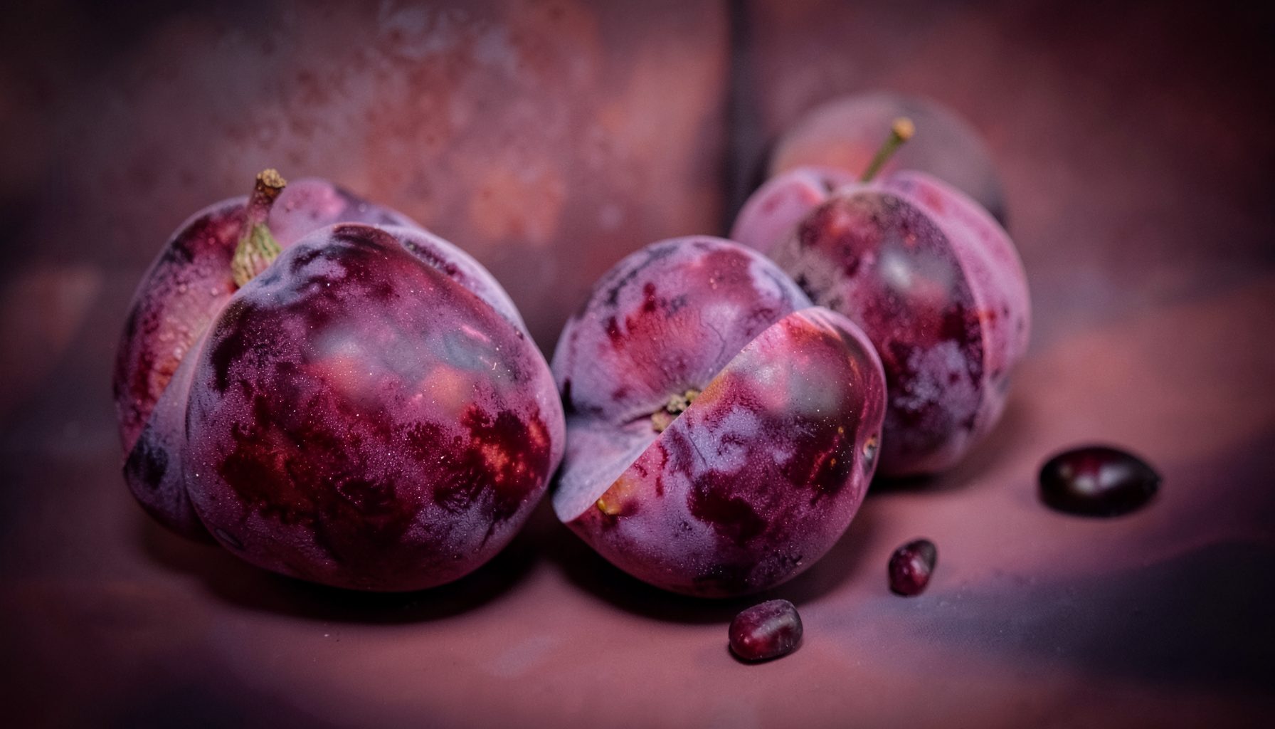 Rich plum and dusty rose abstract composition with subtle vignette, dramatic and elegant mood
